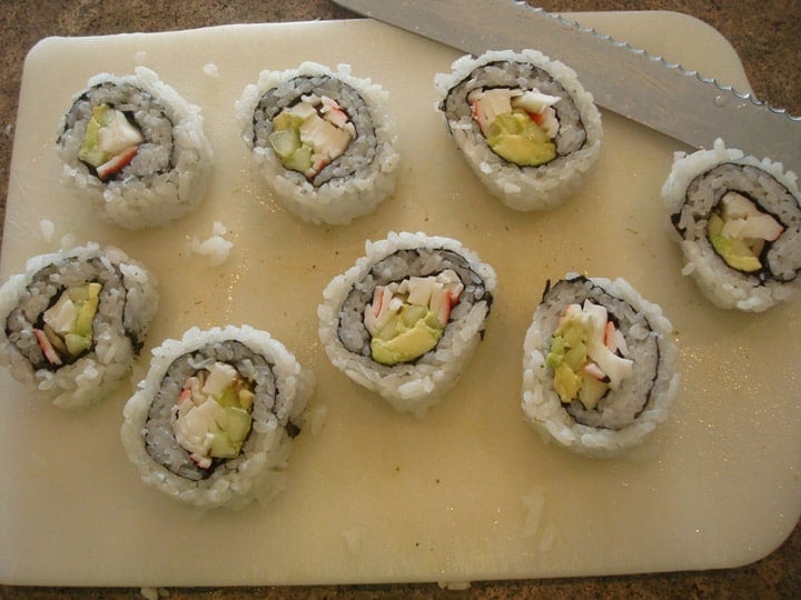 https://www.melskitchencafe.com/2010/04/california-sushi-rolls-a-how-to.html/rice-outside-rolls-all-cut-on-cutting-board-2